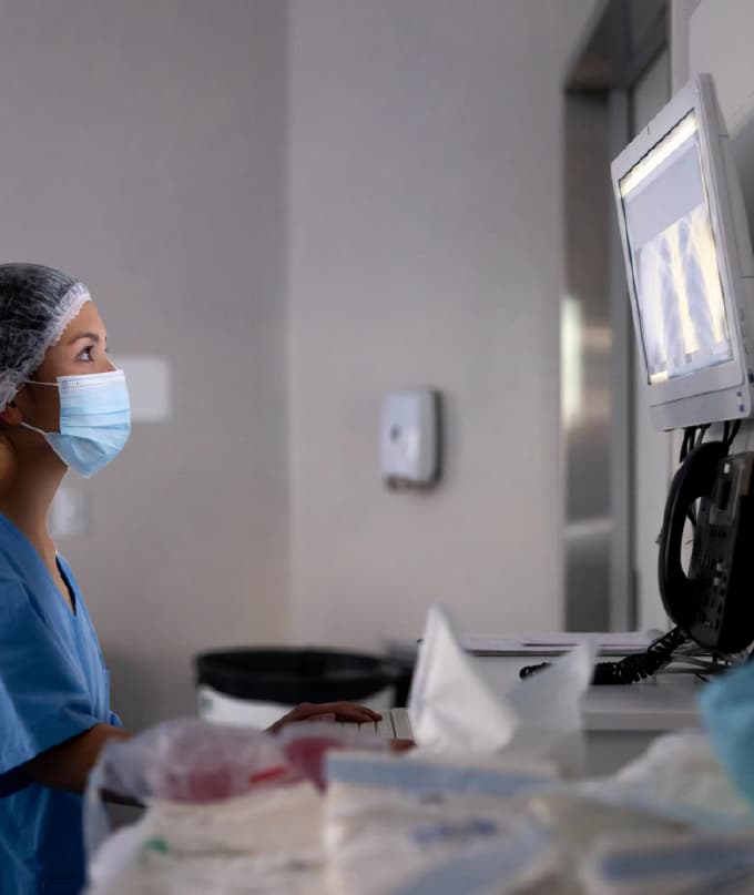 Clinician reviewing diagnostic imaging on a medical display